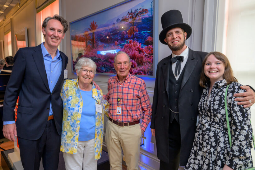 Group of people smiling at an event.