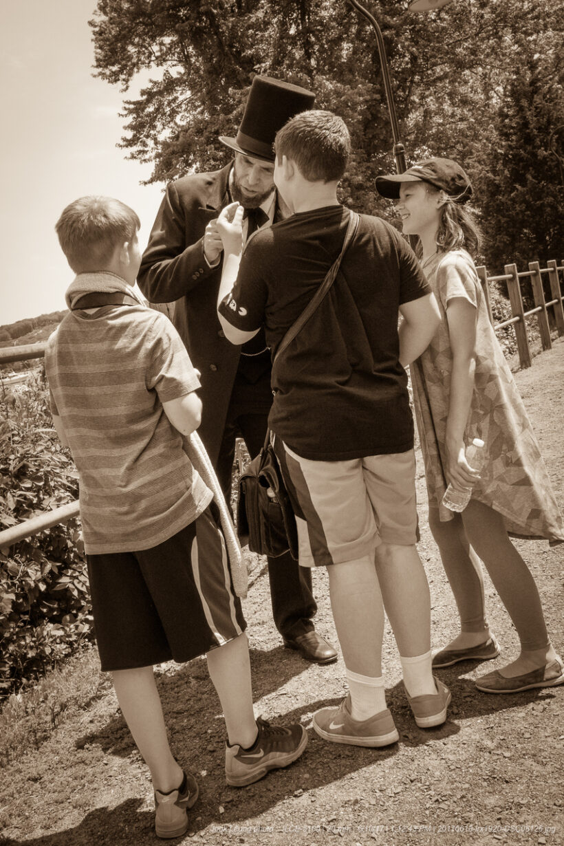 Man in top hat with three children.