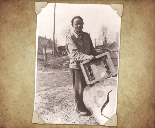 Man holding a picture frame outdoors.