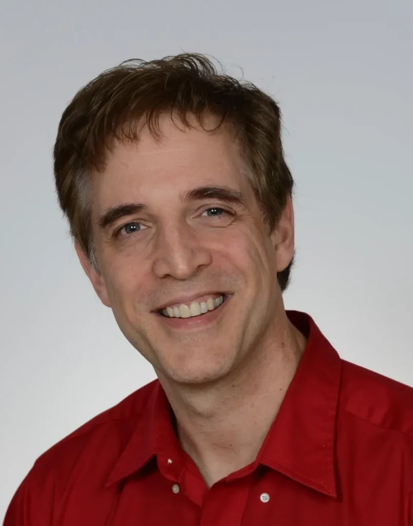 Smiling person wearing a red shirt.