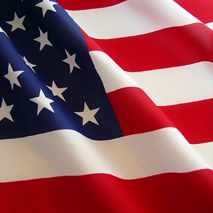 Waving United States flag with stars and stripes.