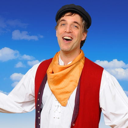 Man in vintage outfit with orange scarf.