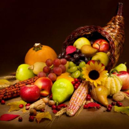 Cornucopia with fruits, vegetables, and leaves.